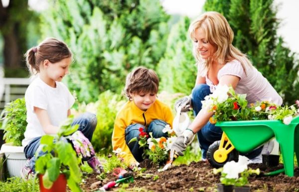 Kids doing some gardening with mum Maxx Life Gym Armagh